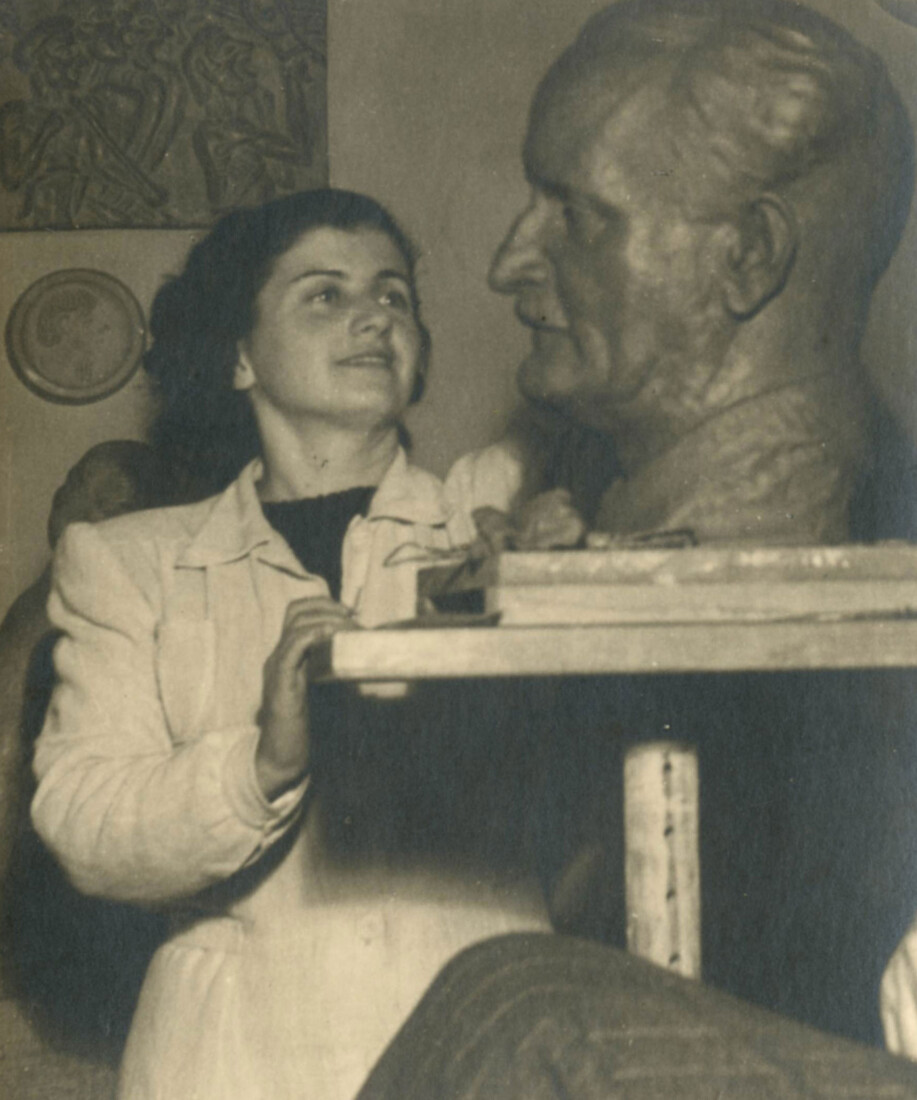 The sculptress working on a bust in clay