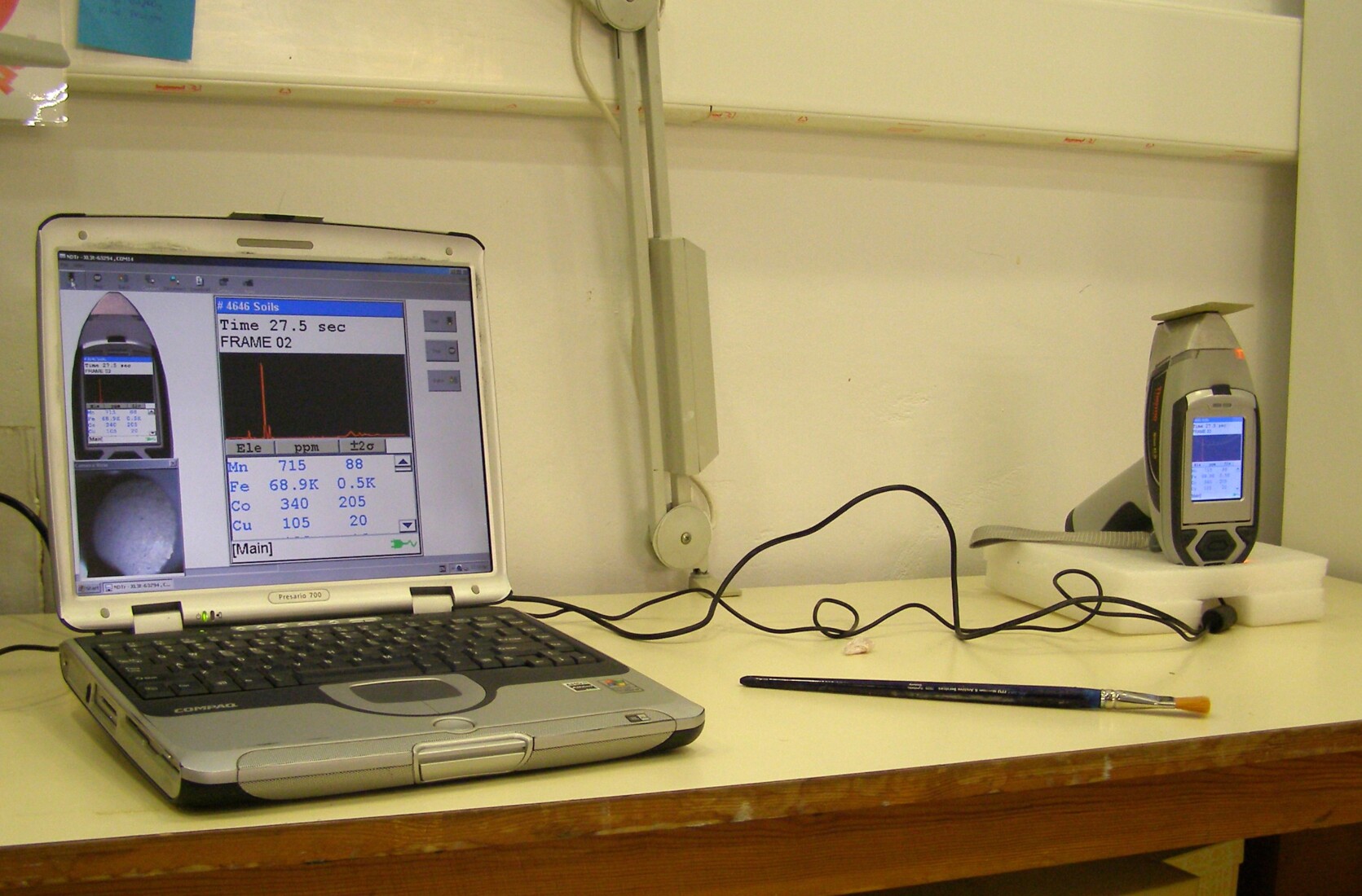 Photo during analysing a ceramic tile by portable X-ray fluorescence device